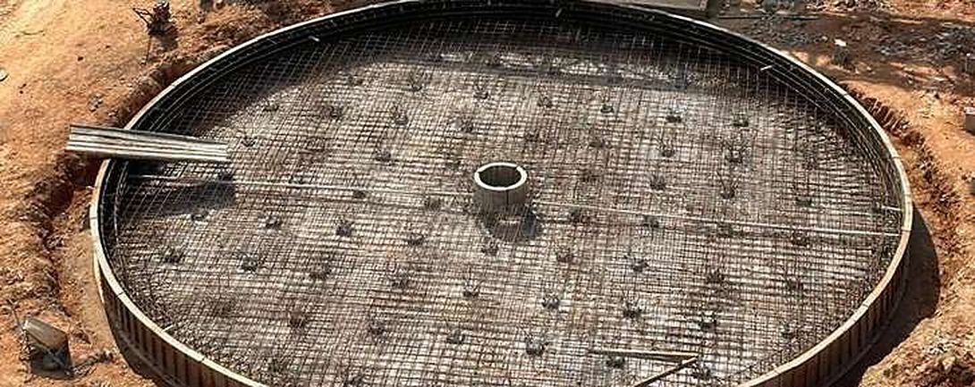 Tank foundation with reinforcement and pile caps